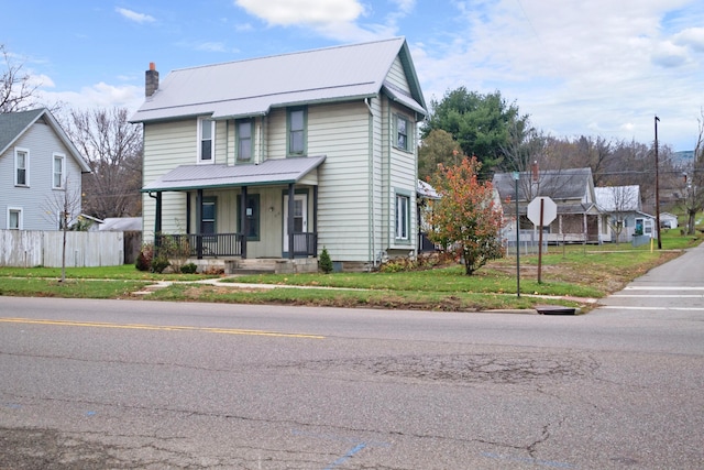 front of property featuring a porch and a front lawn