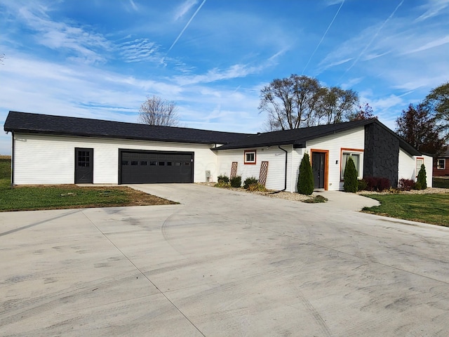 single story home featuring a front yard and a garage