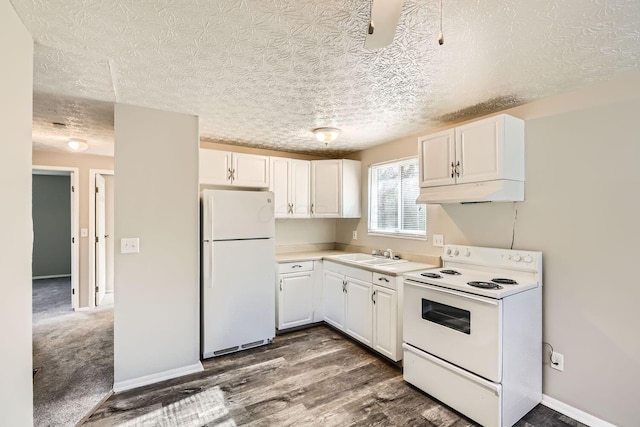 kitchen featuring white cabinetry, sink, dark hardwood / wood-style floors, and white appliances