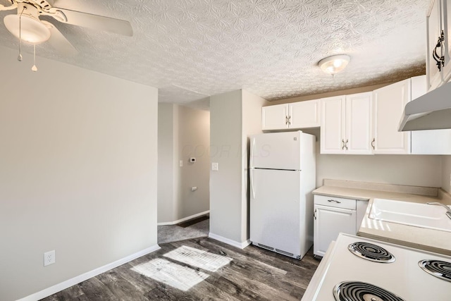 kitchen featuring white cabinets, sink, ceiling fan, white fridge, and dark hardwood / wood-style flooring