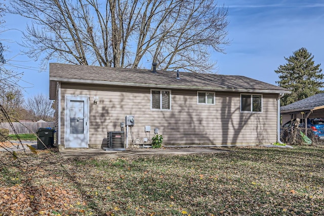 back of house with a lawn, cooling unit, and a patio