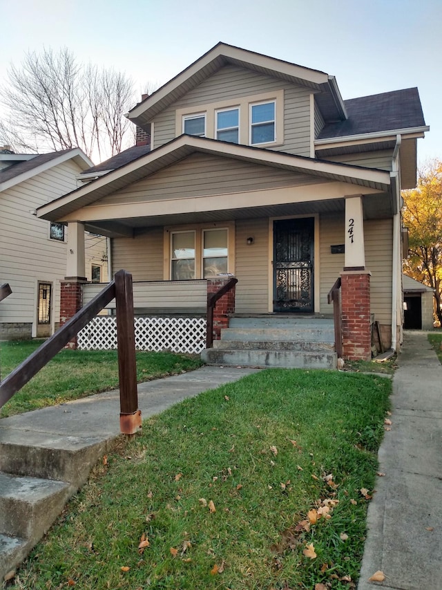 view of front of home with a porch and a front lawn