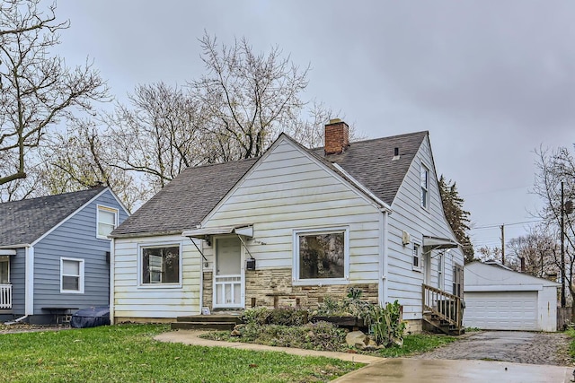 bungalow featuring an outbuilding, a front lawn, and a garage