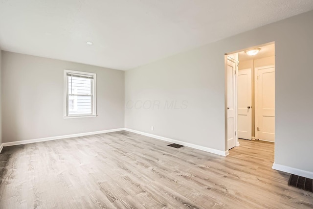 unfurnished room featuring light wood-type flooring