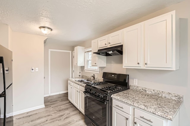 kitchen featuring black gas range, white cabinetry, sink, light stone countertops, and light hardwood / wood-style floors