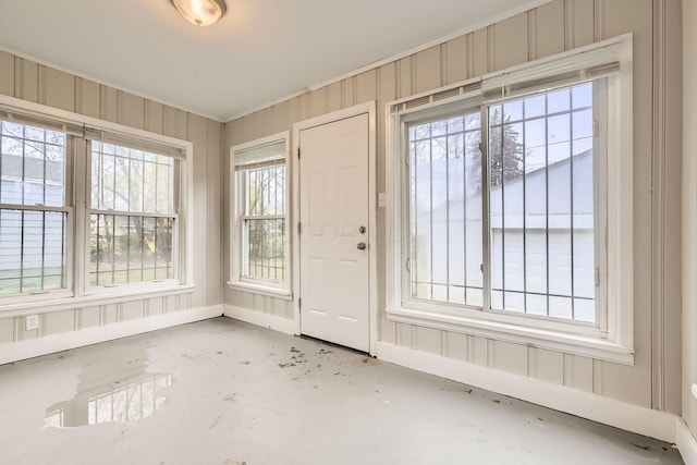 interior space featuring plenty of natural light and wood walls