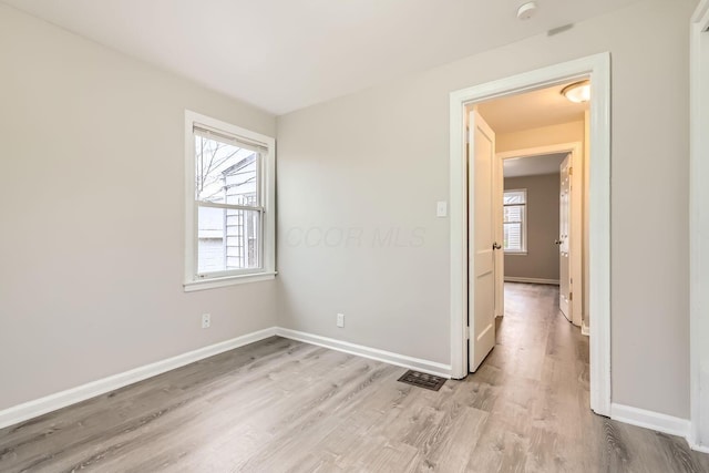 spare room featuring light wood-type flooring