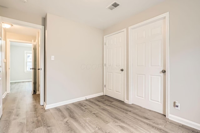 unfurnished bedroom with light hardwood / wood-style floors