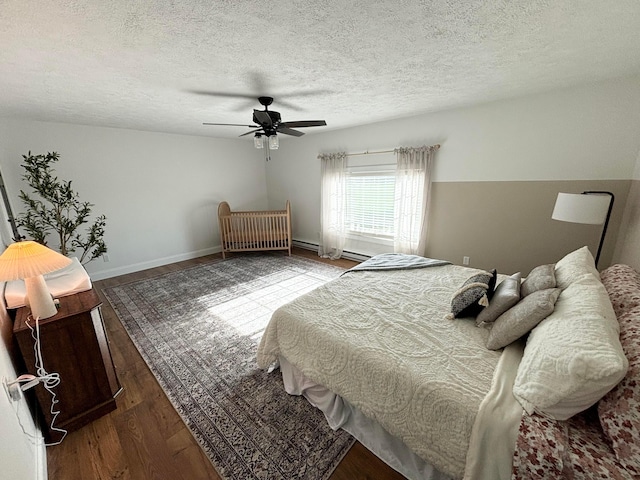 bedroom with a textured ceiling, dark hardwood / wood-style floors, and ceiling fan