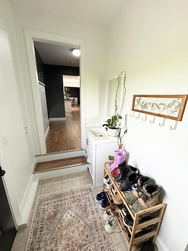 mudroom featuring sink and light wood-type flooring