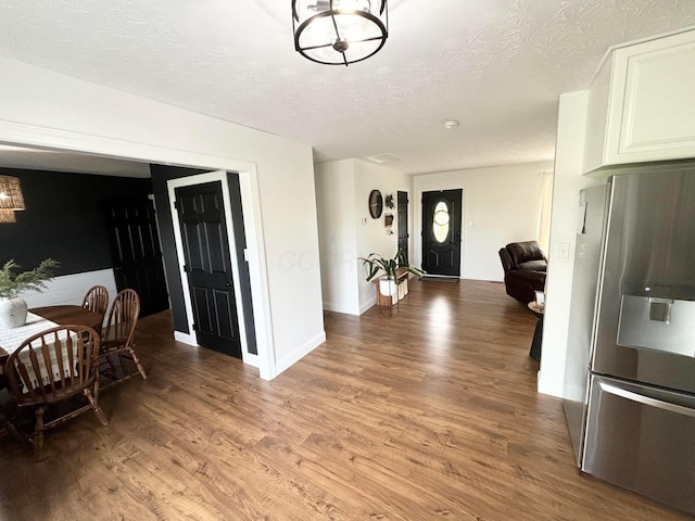 foyer entrance featuring wood-type flooring and a textured ceiling