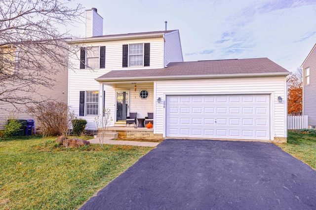 front of property with a front yard and a garage