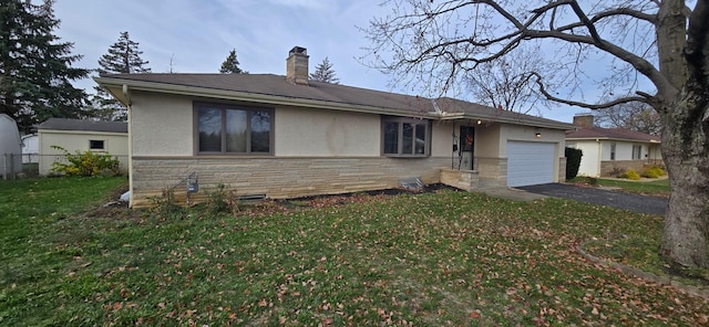 view of front of property with a garage and a front yard