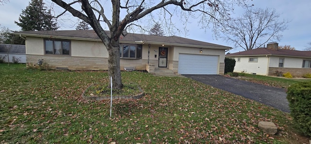 ranch-style house with a garage and a front lawn