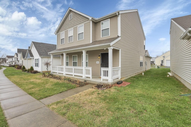 view of front of home featuring a front yard and covered porch