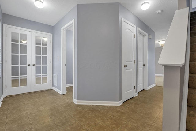 hall with light tile patterned floors and french doors