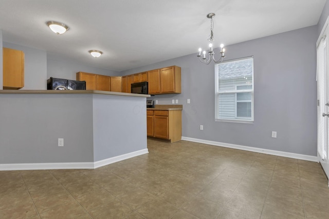 kitchen with black appliances, a chandelier, light tile patterned flooring, and hanging light fixtures