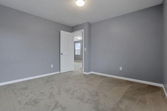 empty room featuring carpet floors and a textured ceiling