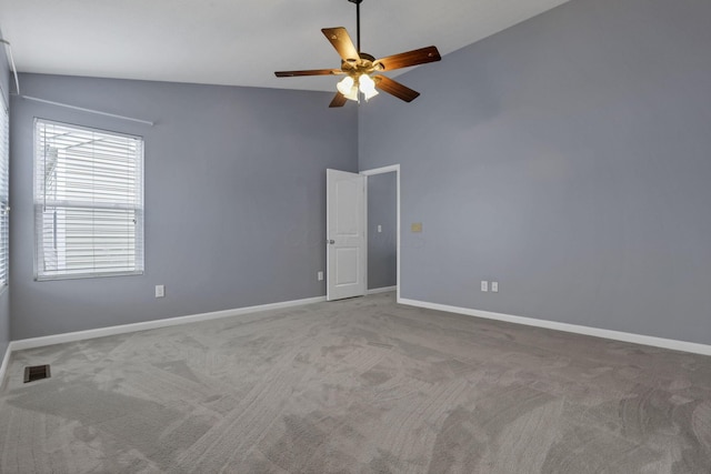 carpeted empty room with ceiling fan and lofted ceiling