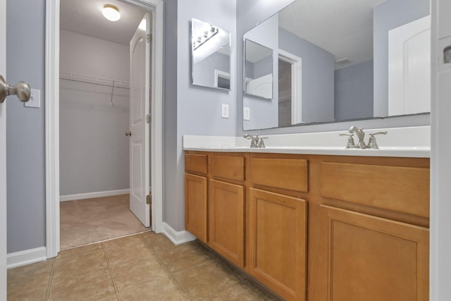 bathroom with a textured ceiling, vanity, and tile patterned floors