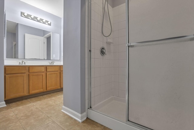 bathroom featuring vanity, tile patterned floors, and a shower with door