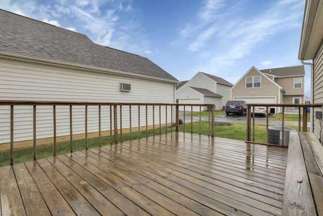 wooden deck featuring a lawn and central air condition unit