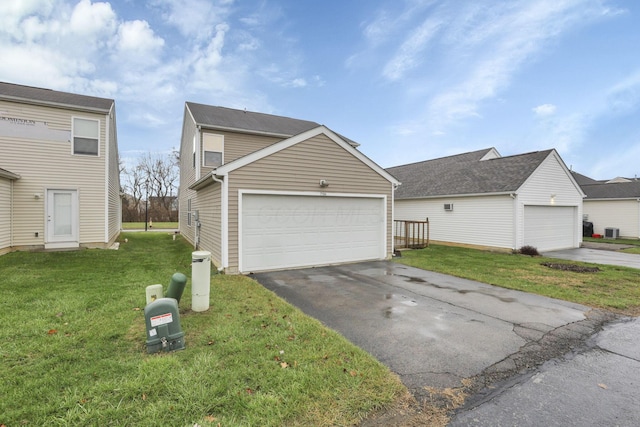 view of side of home with central AC, a garage, and a lawn