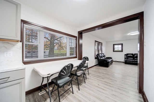 dining area featuring light hardwood / wood-style flooring and a wealth of natural light