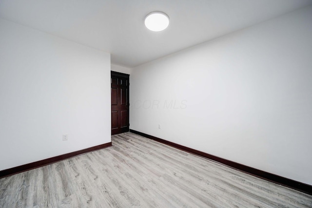 empty room with light hardwood / wood-style flooring