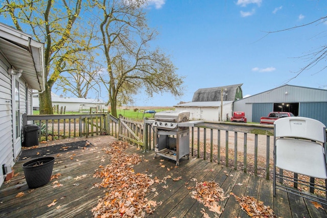 wooden terrace with an outbuilding and a garage