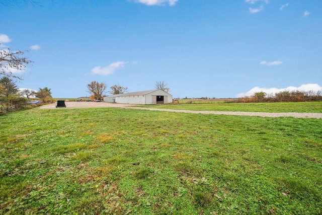 view of yard featuring a rural view and an outdoor structure