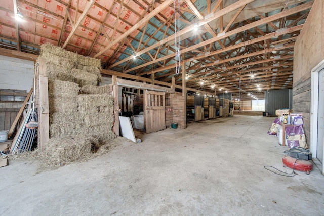 misc room with concrete floors and lofted ceiling