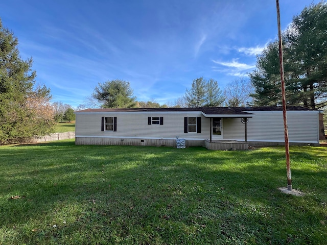 rear view of property with a yard