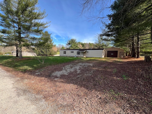 view of front of house with an outbuilding, a garage, and a front lawn