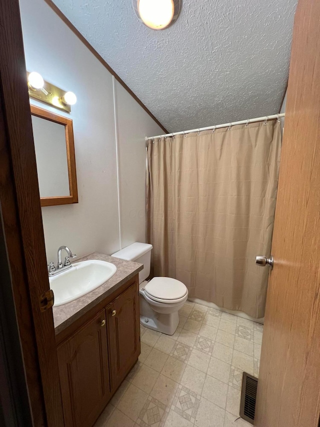 bathroom with a shower with shower curtain, vanity, a textured ceiling, crown molding, and toilet