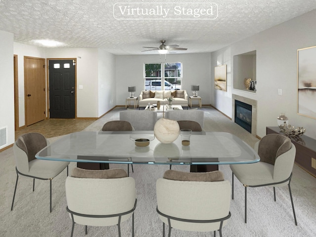 dining space featuring ceiling fan and a textured ceiling