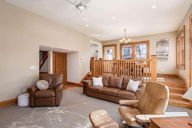 living area with recessed lighting, stairway, baseboards, and ceiling fan with notable chandelier