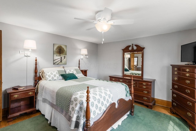 bedroom with ceiling fan and wood finished floors