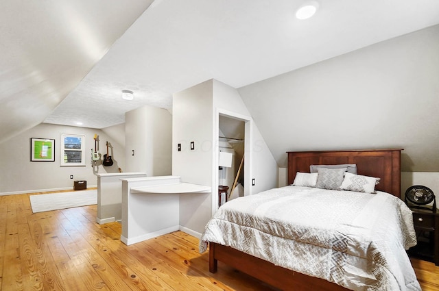 bedroom featuring vaulted ceiling and light hardwood / wood-style flooring