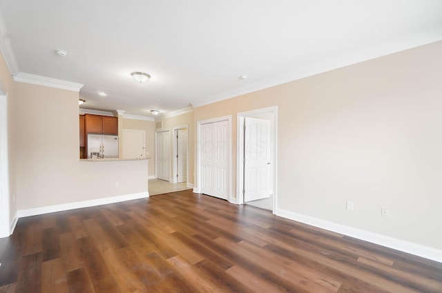 unfurnished living room with dark hardwood / wood-style floors and ornamental molding