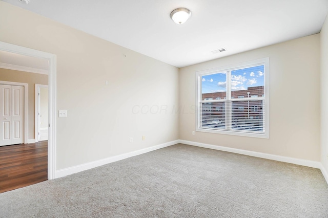 unfurnished room with dark hardwood / wood-style flooring and crown molding