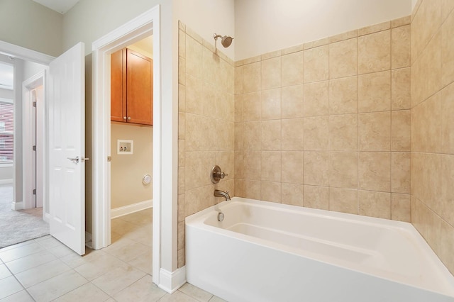 bathroom featuring tile patterned flooring and tiled shower / bath