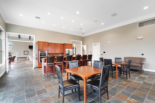 dining space with ornamental molding