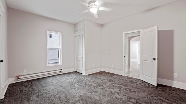 unfurnished bedroom featuring baseboards, carpet flooring, ceiling fan, and baseboard heating