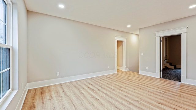 unfurnished room with recessed lighting, baseboards, and wood finished floors