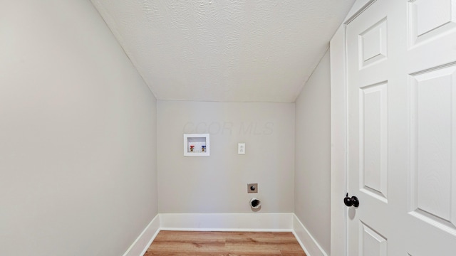 washroom with light wood-style flooring, hookup for an electric dryer, laundry area, washer hookup, and baseboards