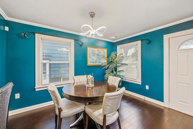 dining area featuring dark hardwood / wood-style flooring and crown molding