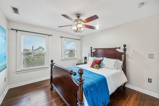 bedroom with dark hardwood / wood-style floors and ceiling fan