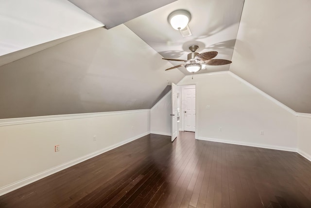 additional living space with ceiling fan, dark hardwood / wood-style flooring, and vaulted ceiling