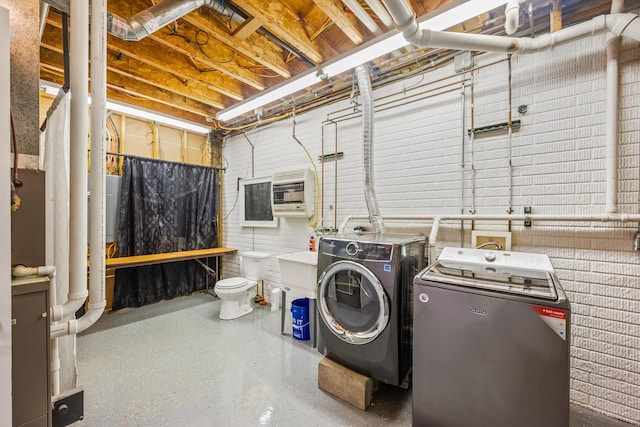 laundry room featuring separate washer and dryer and heating unit